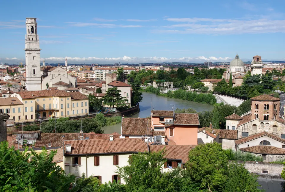 The Adige River between Verona Cathedral and San Giorgio in Braida, viewed from above red rooftops